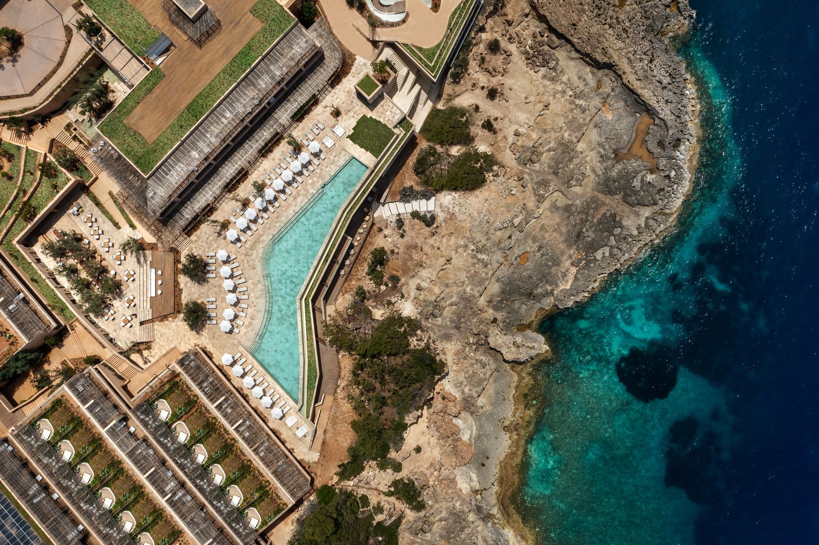 Image may contain Pool Water Swimming Pool Outdoors Nature Sea Aerial View Architecture Building and Coast
