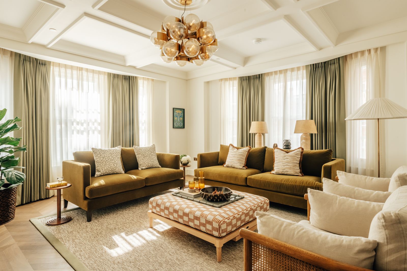 Image may contain Home Decor Furniture Chandelier Lamp Couch Architecture Building Indoors Living Room and Room