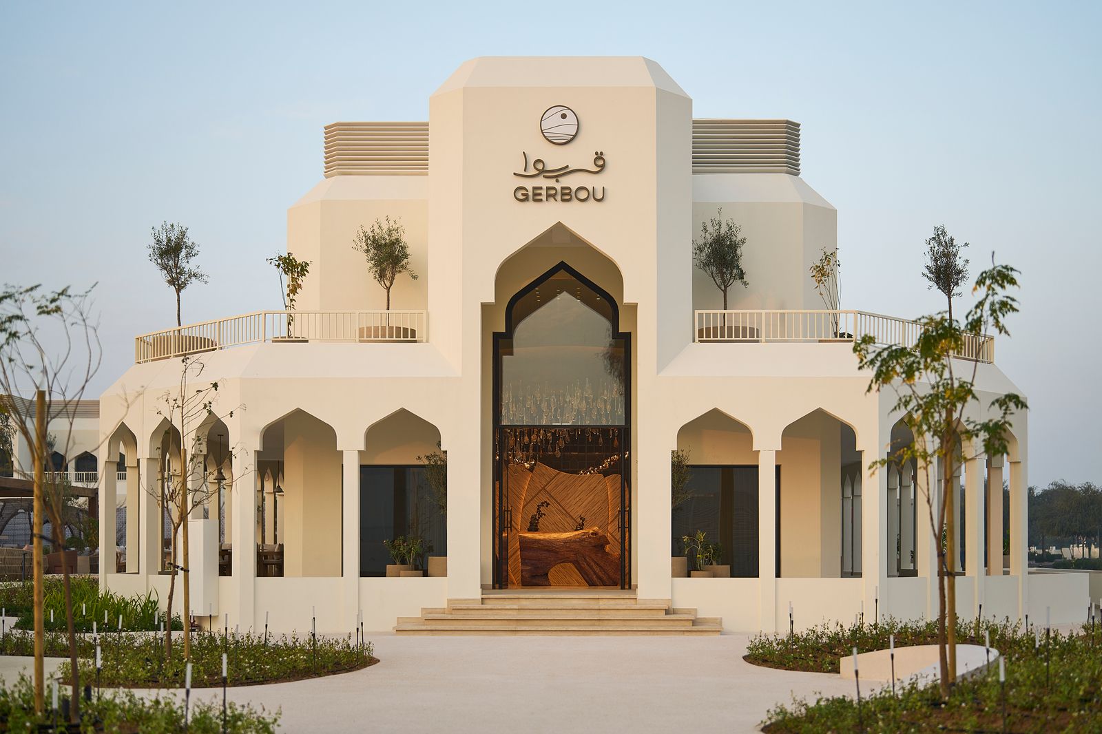 Image may contain Architecture Building House Housing Villa Plant Water Waterfront Hacienda and Person