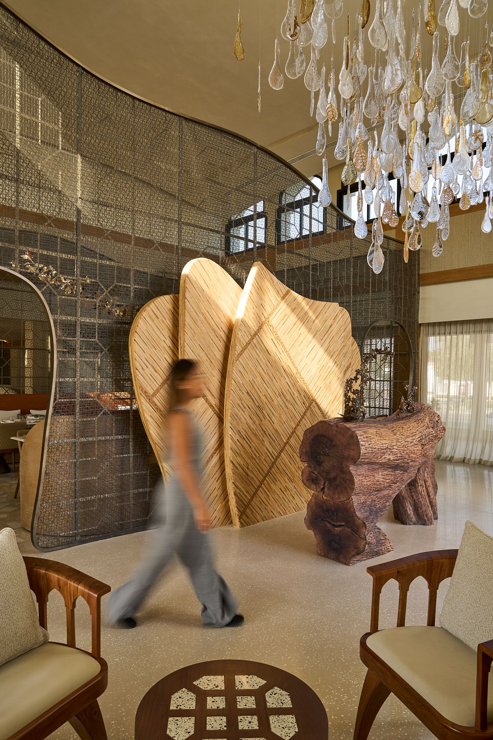 Image may contain Chair Furniture Chandelier Lamp Adult Person Indoors Interior Design Architecture and Building