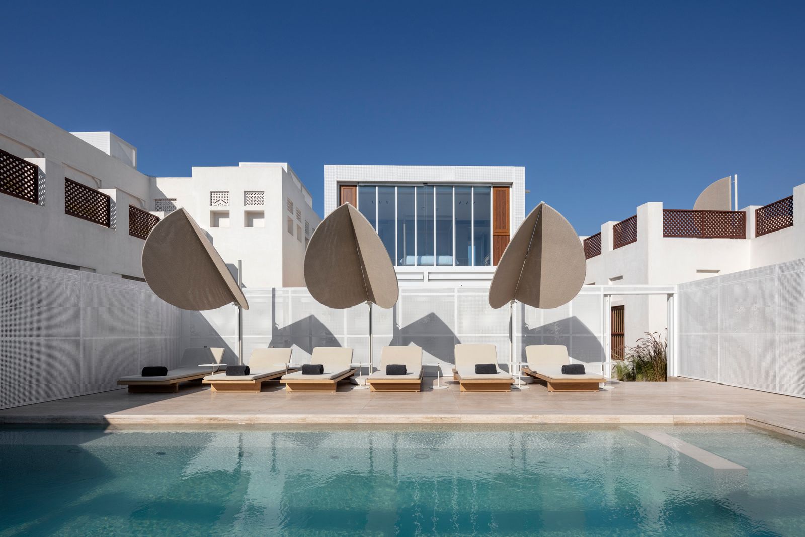 Image may contain Pool Water Swimming Pool Chair Furniture Architecture Building House Housing and Villa