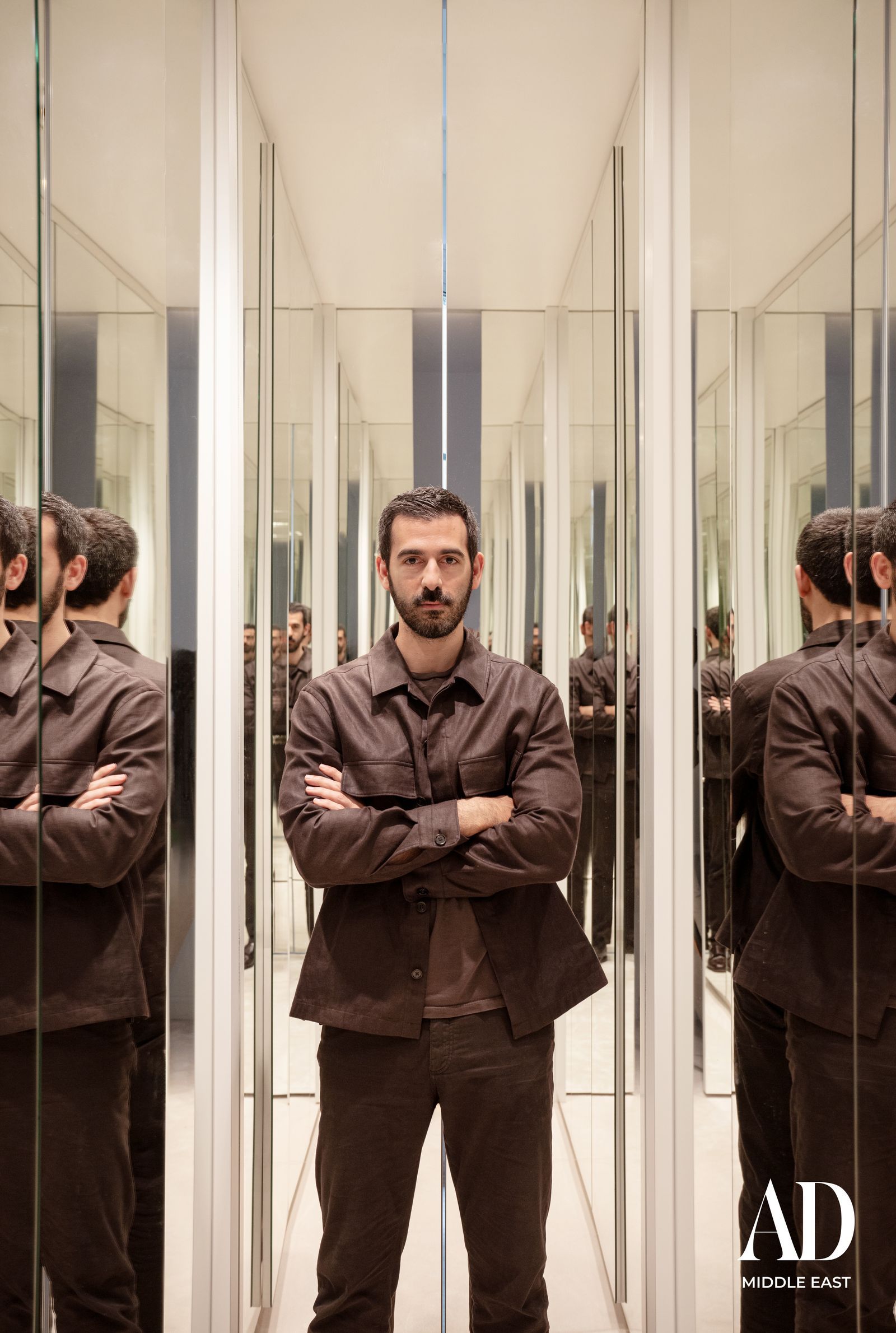 Image may contain Adult Person Indoors Clothing Coat Elevator and Door