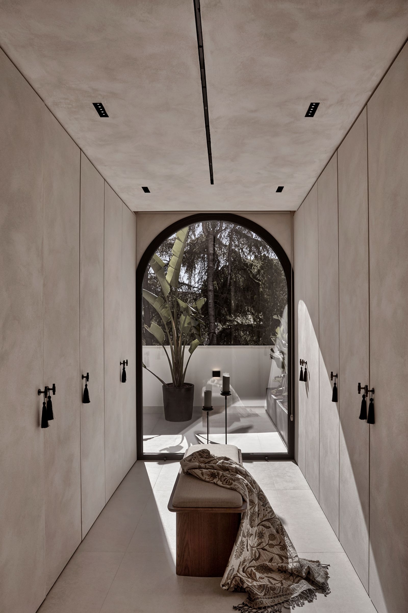 Image may contain Indoors Interior Design Floor Architecture Building Foyer Candle Plant and Arch