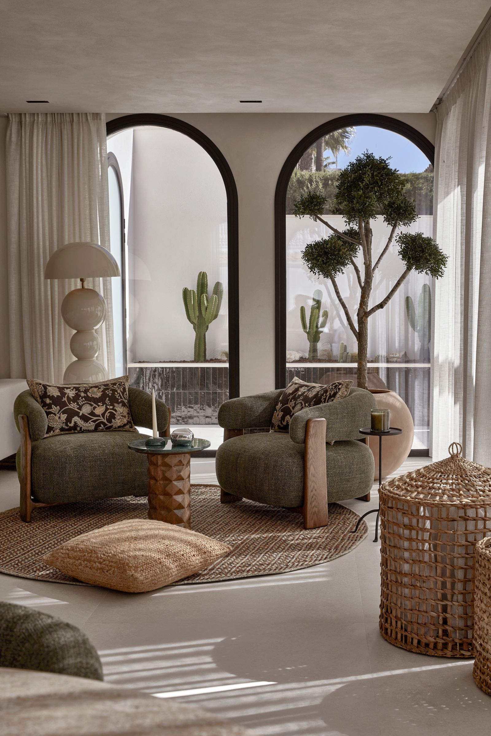 Image may contain Home Decor Furniture Table Rug Architecture Building Indoors Living Room Room Lamp and Couch