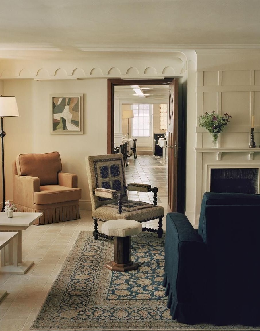 Image may contain Home Decor Lamp Chair Furniture Indoors Rug Art Painting Couch Architecture Building and Foyer