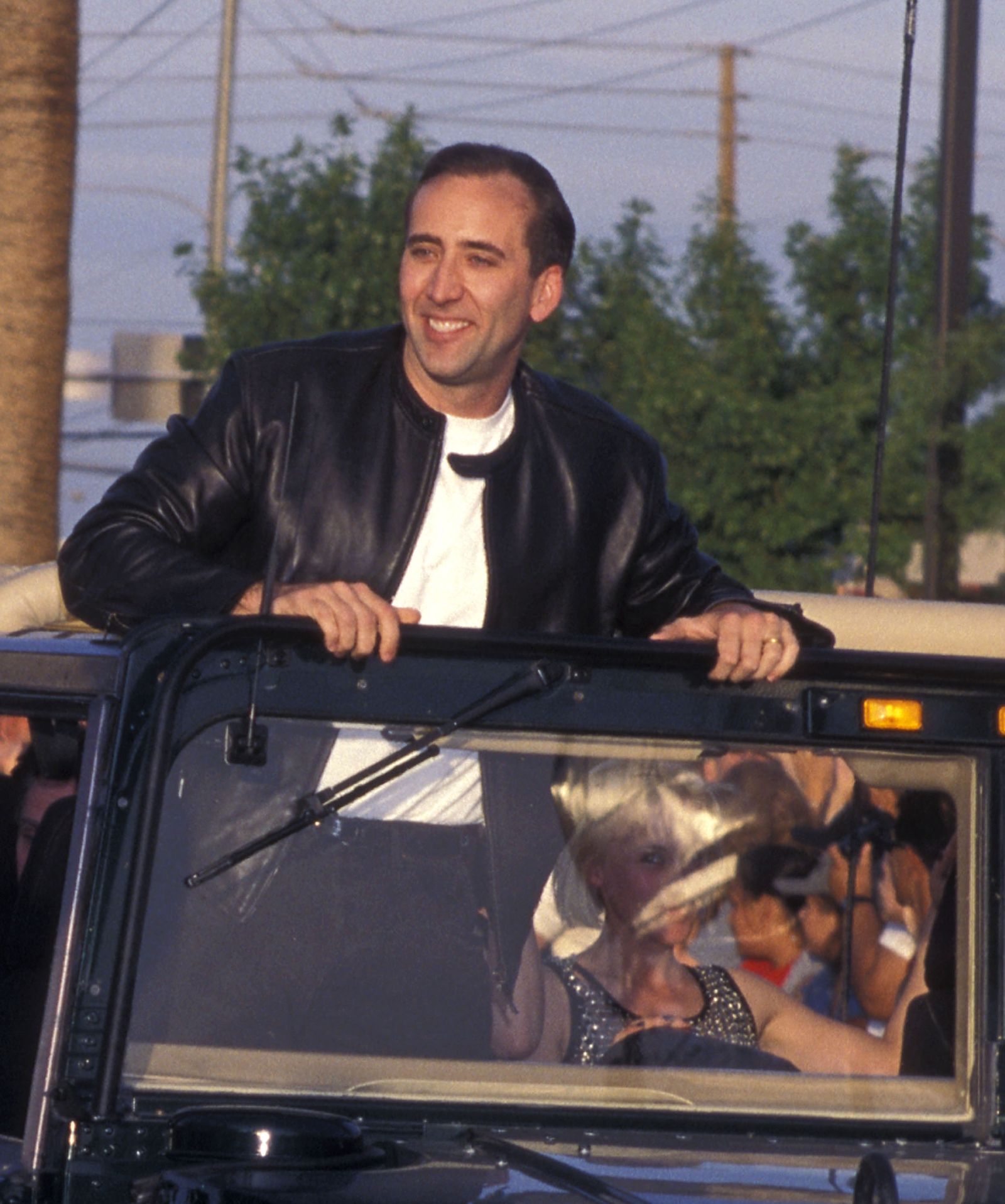 Image may contain Nicolas Cage Clothing Coat Jacket Face Head Person Photography Portrait Adult and Child
