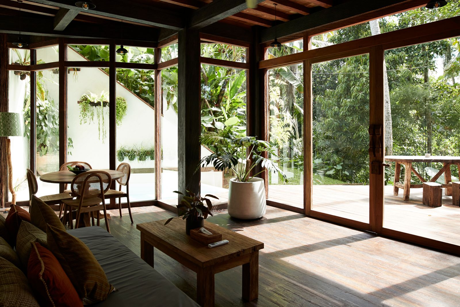Image may contain Indoors Interior Design Plant Furniture Table Chair Electronics Remote Control and Wood