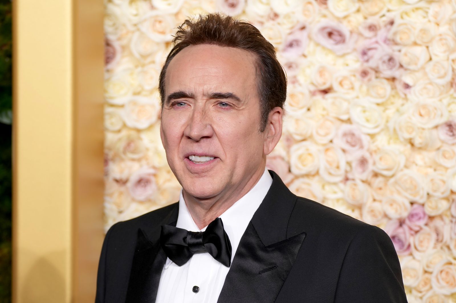 Image may contain Nicolas Cage Face Head Person Photography Portrait Clothing Formal Wear Suit and Adult