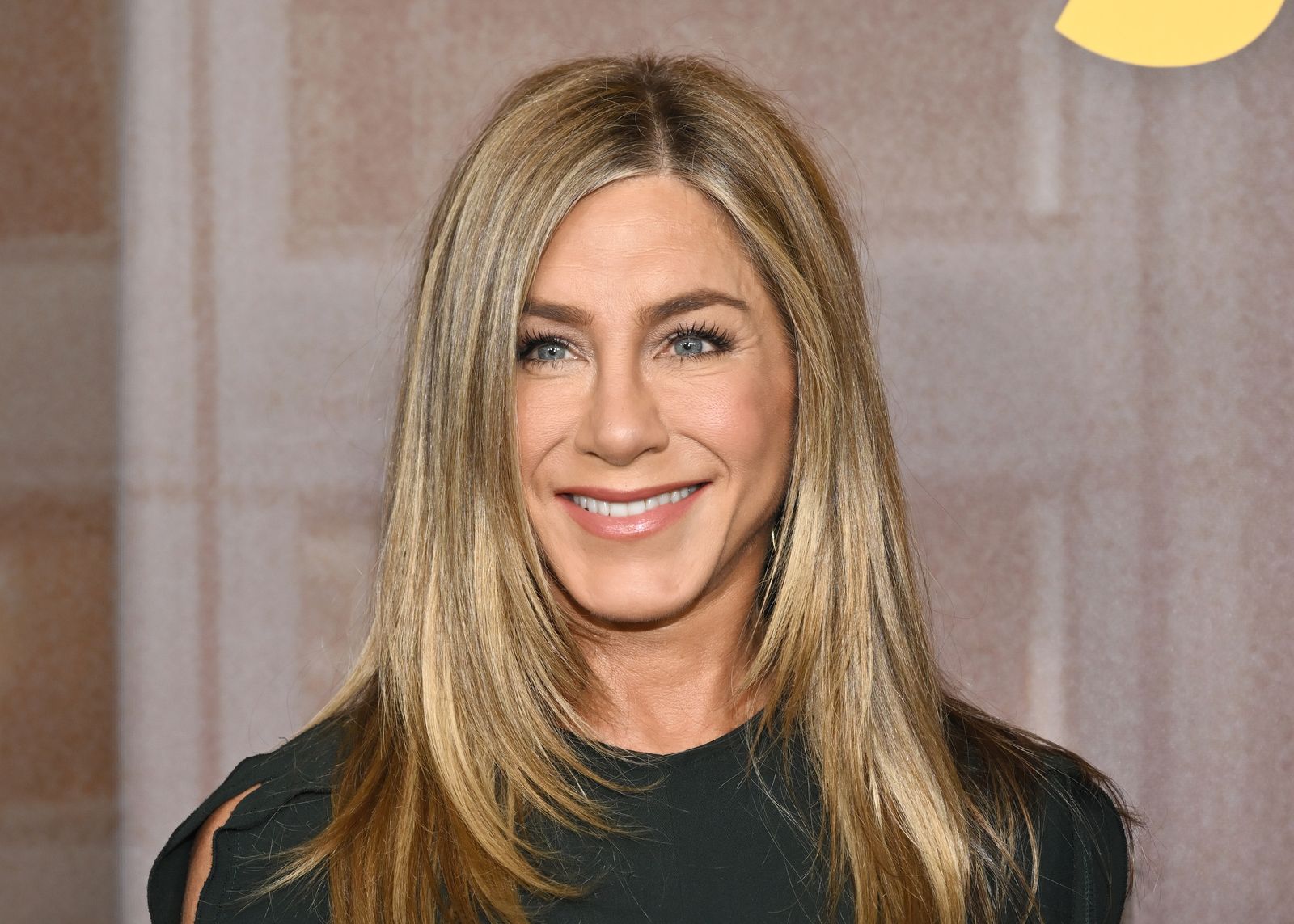 Image may contain Jennifer Aniston Blonde Hair Person Adult Head Face Happy Smile Photography and Portrait