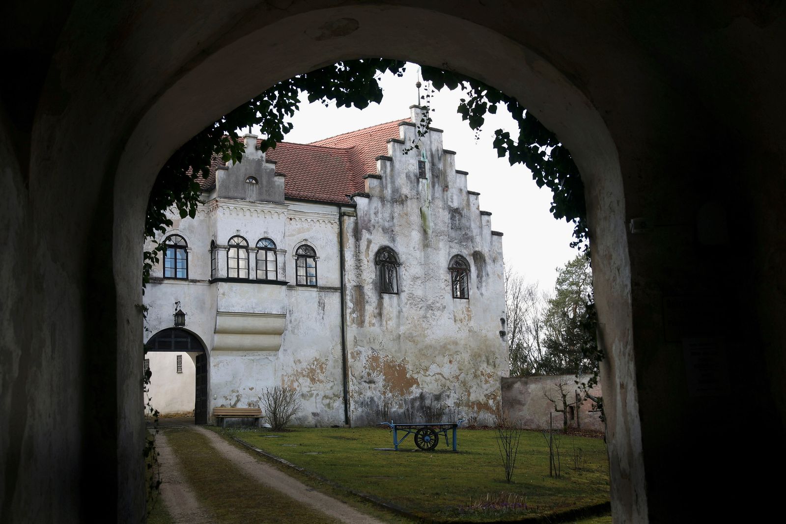 Image may contain Architecture Building Monastery Arch House Housing Villa Gothic Arch Grass Plant and Bench