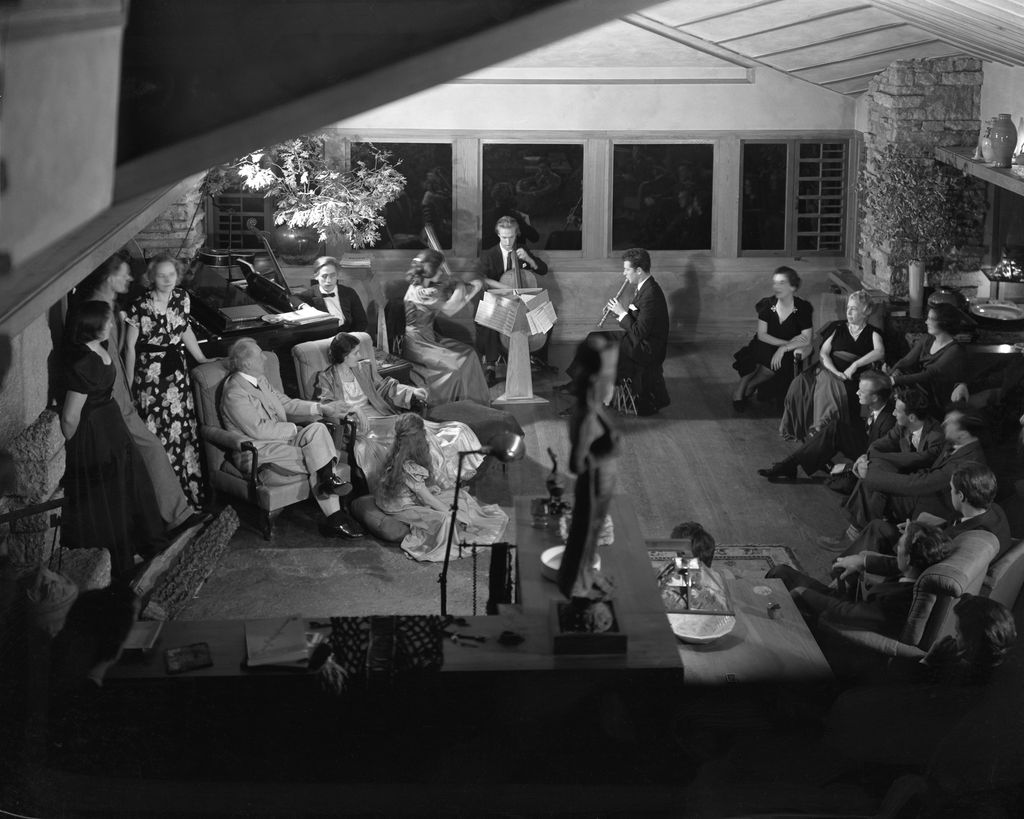 The architect Frank Lloyd Wright enjoys a musical performance with members of his family and the Taliesin Fellowship at...
