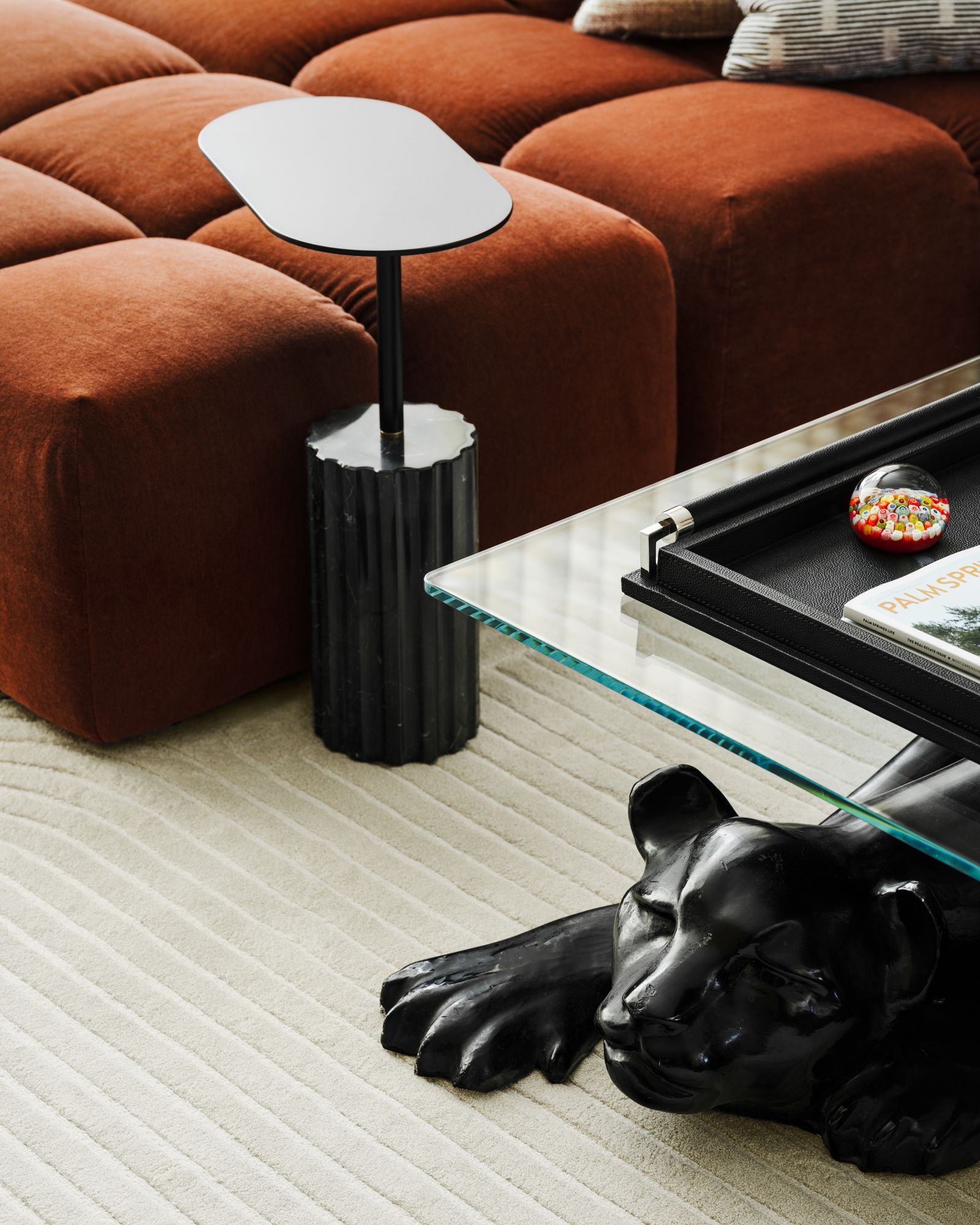 Image may contain Lamp Furniture Table Clothing Glove Coffee Table and Table Lamp