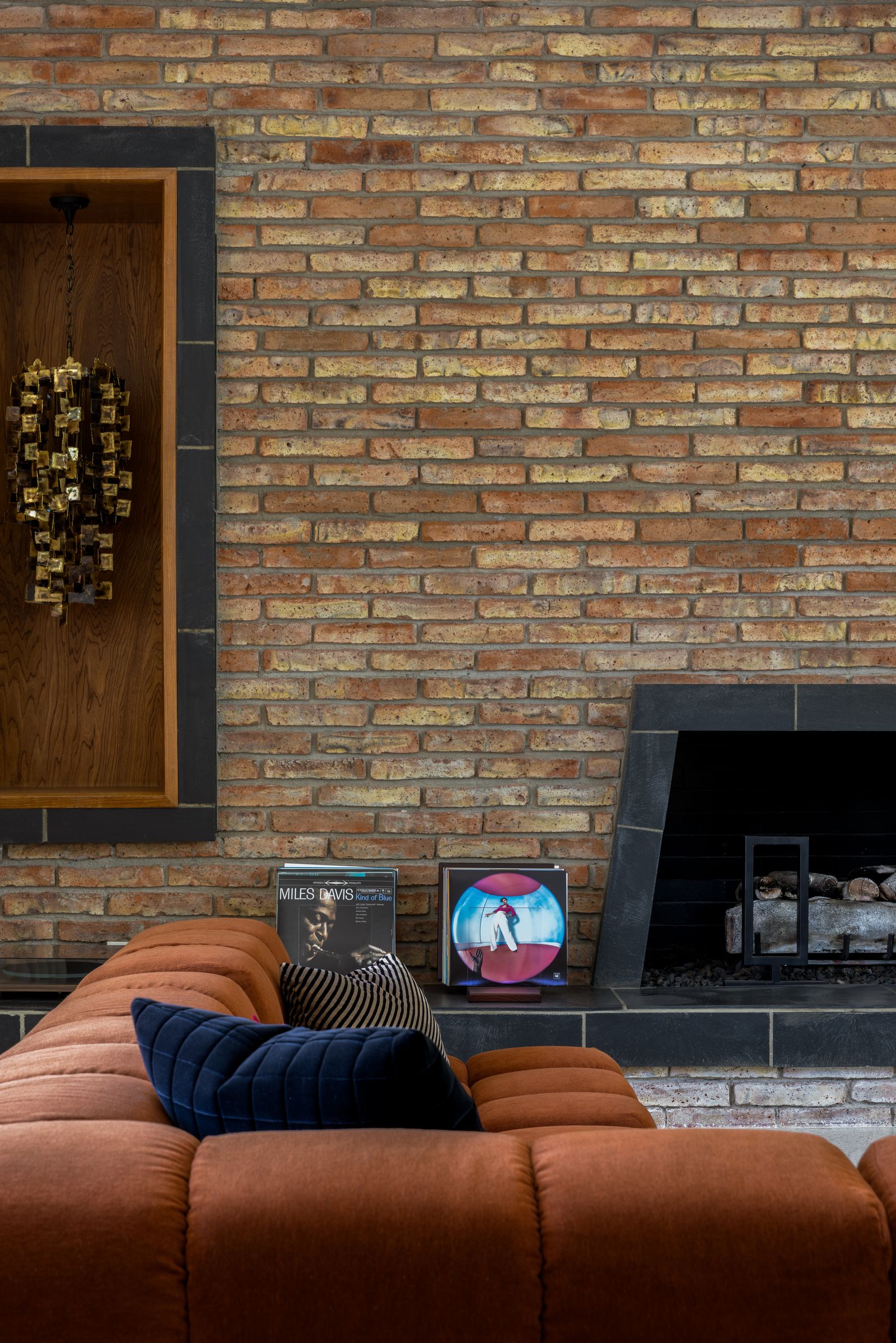 Image may contain Indoors Interior Design Fireplace Brick Architecture Building Wall Home Decor and Person