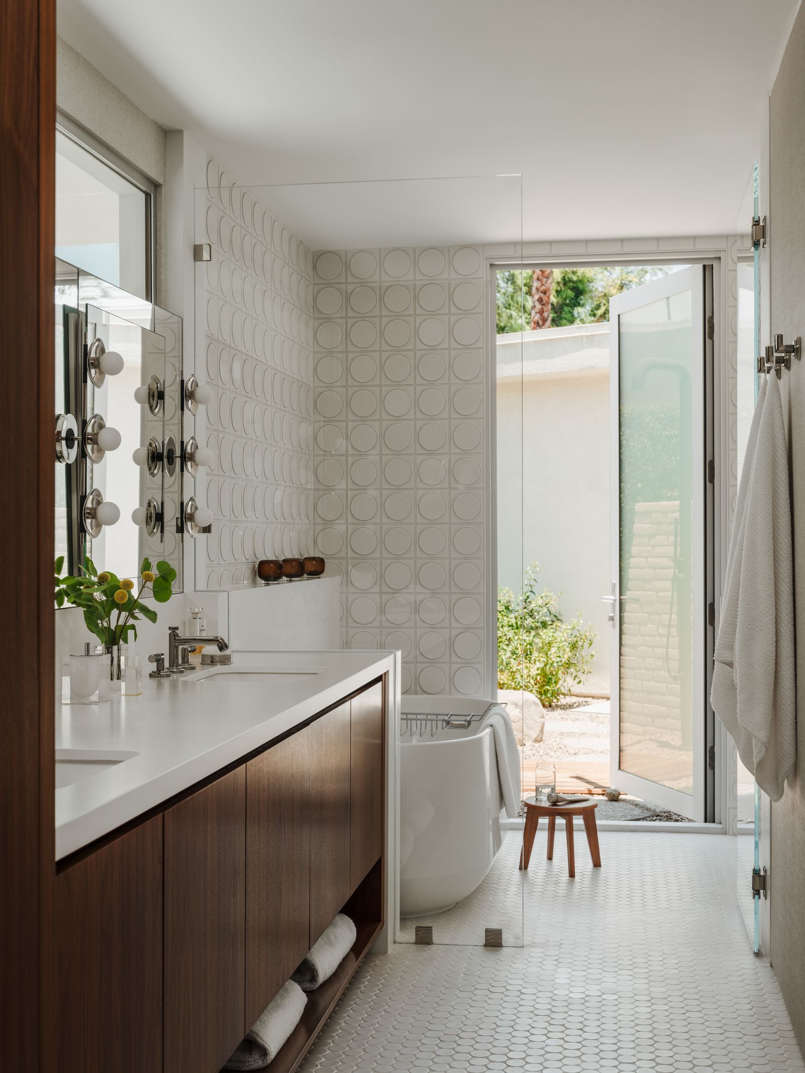 Image may contain Indoors Interior Design Bathing Bathtub Person Tub Sink Bathroom and Room
