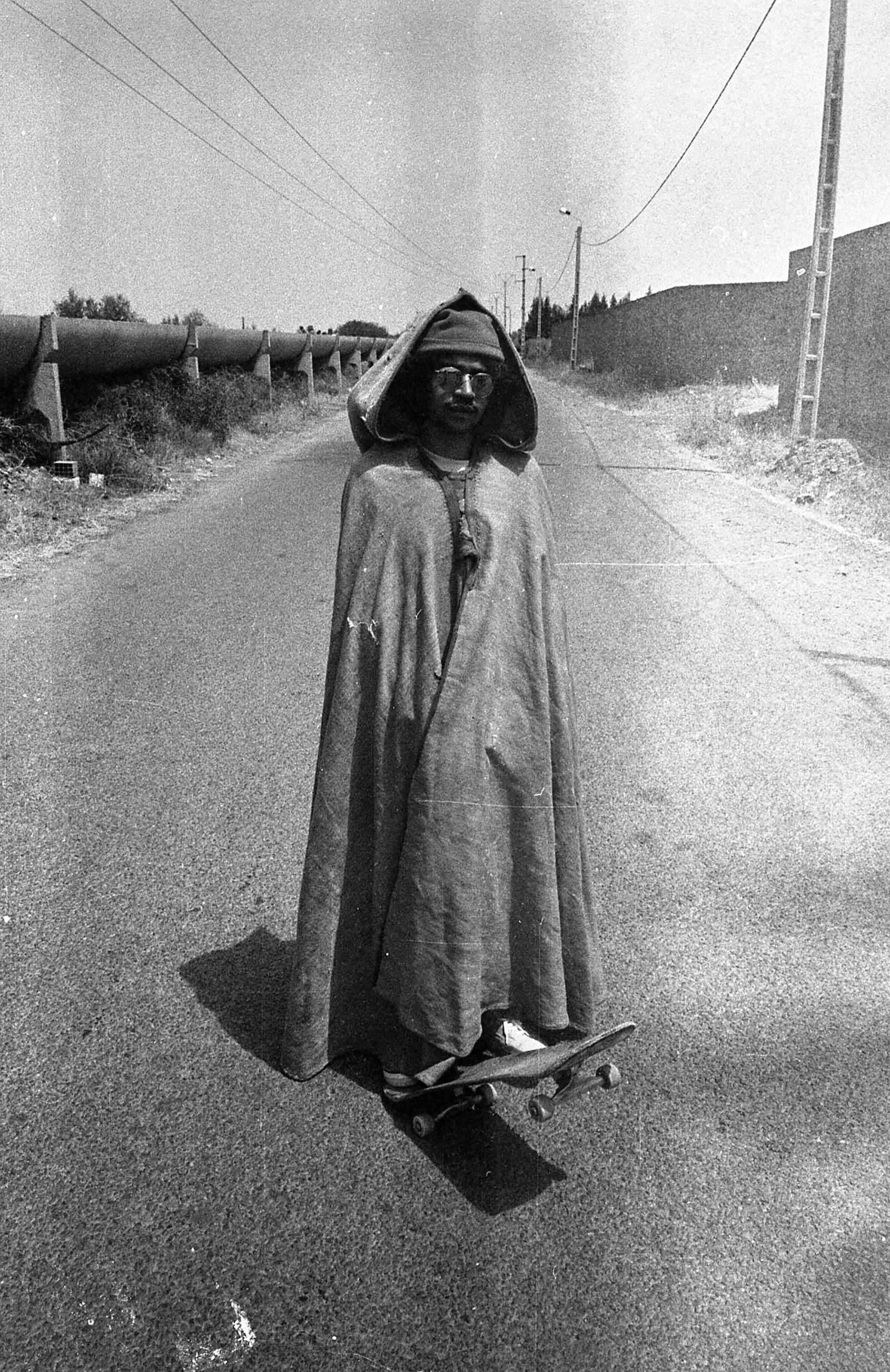Image may contain Moodymann Fashion Adult Person Cloak Clothing Skateboard Accessories Glasses Face and Head