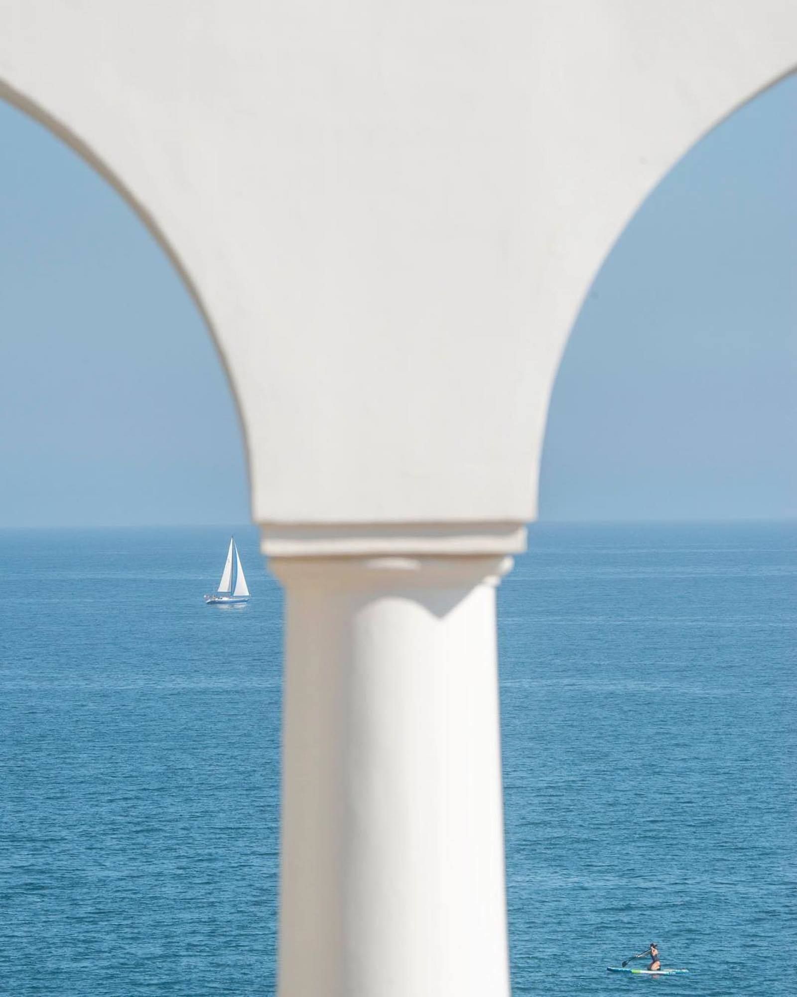Image may contain Boat Transportation Vehicle Sailboat Person Arch Architecture Pillar Nature Outdoors and Sky