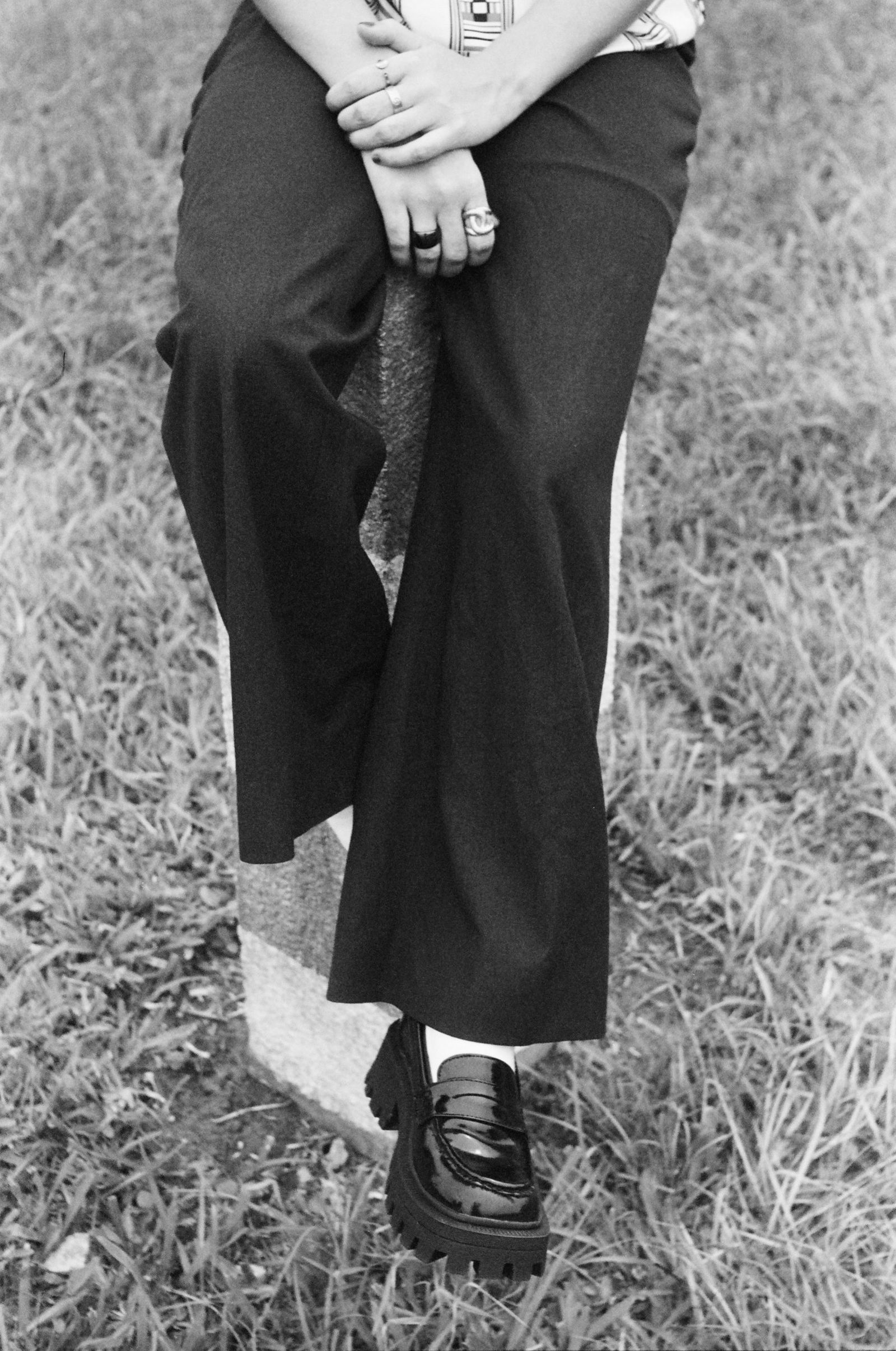 Image may contain Clothing Pants Footwear Shoe Grass Plant Person Sneaker and Shorts