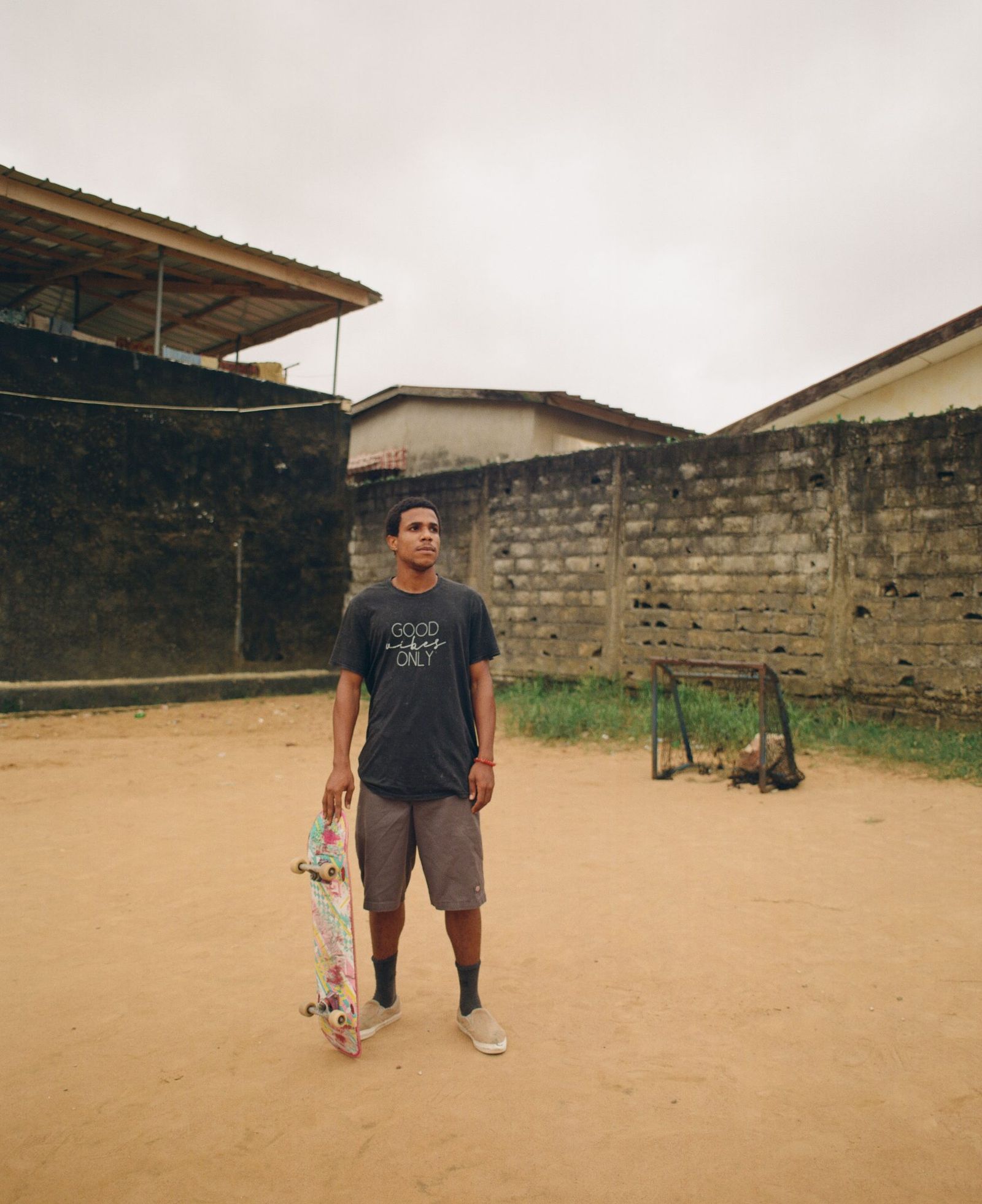 Image may contain Addis Pablo Clothing TShirt Shorts Person Standing Face Head Photography Portrait and Adult