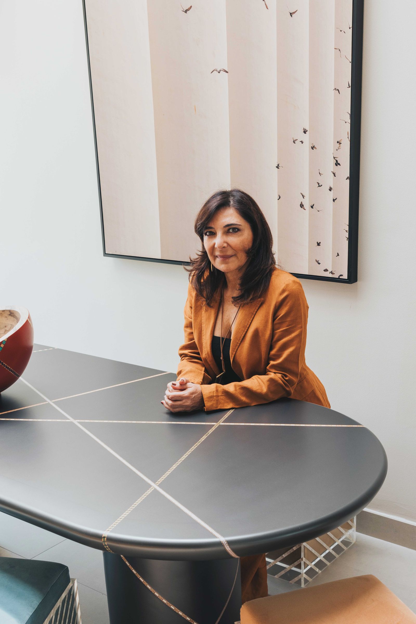 Image may contain Furniture Table Person Sitting Tabletop and Executive