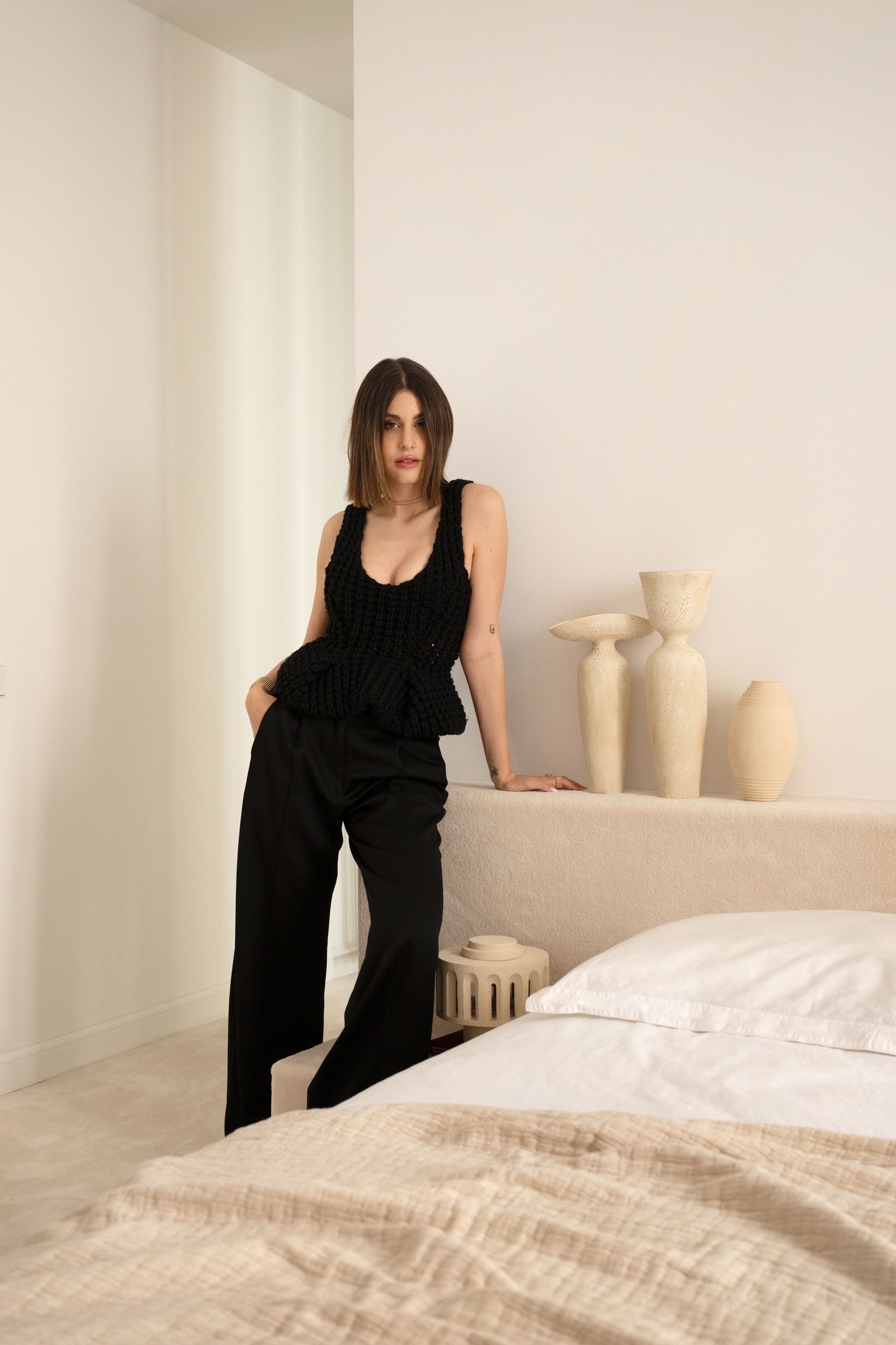 Image may contain Clothing Pants Adult Person Bed Furniture Dress and Formal Wear