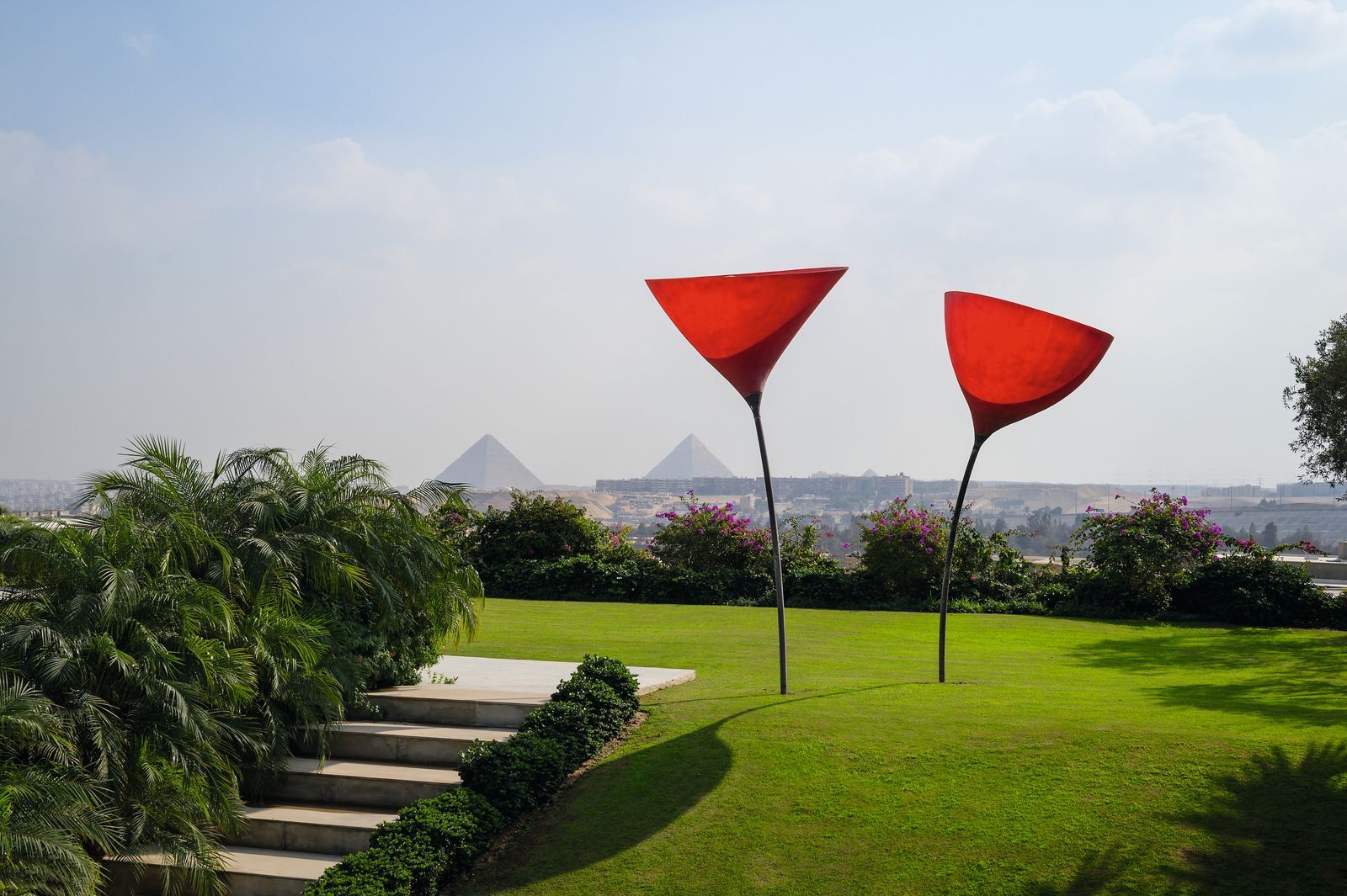 The Most Beautiful Homes in Cairo red artwork in the garden of a  Luxurious Villa in Cairo with the pyramids of giza in...