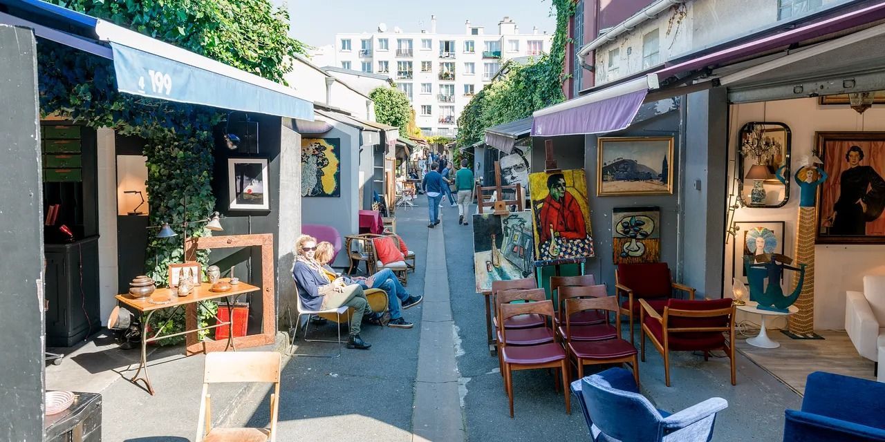 Image may contain City Urban Road Street Desk Furniture Table Person Art Painting Chair Clothing and Footwear