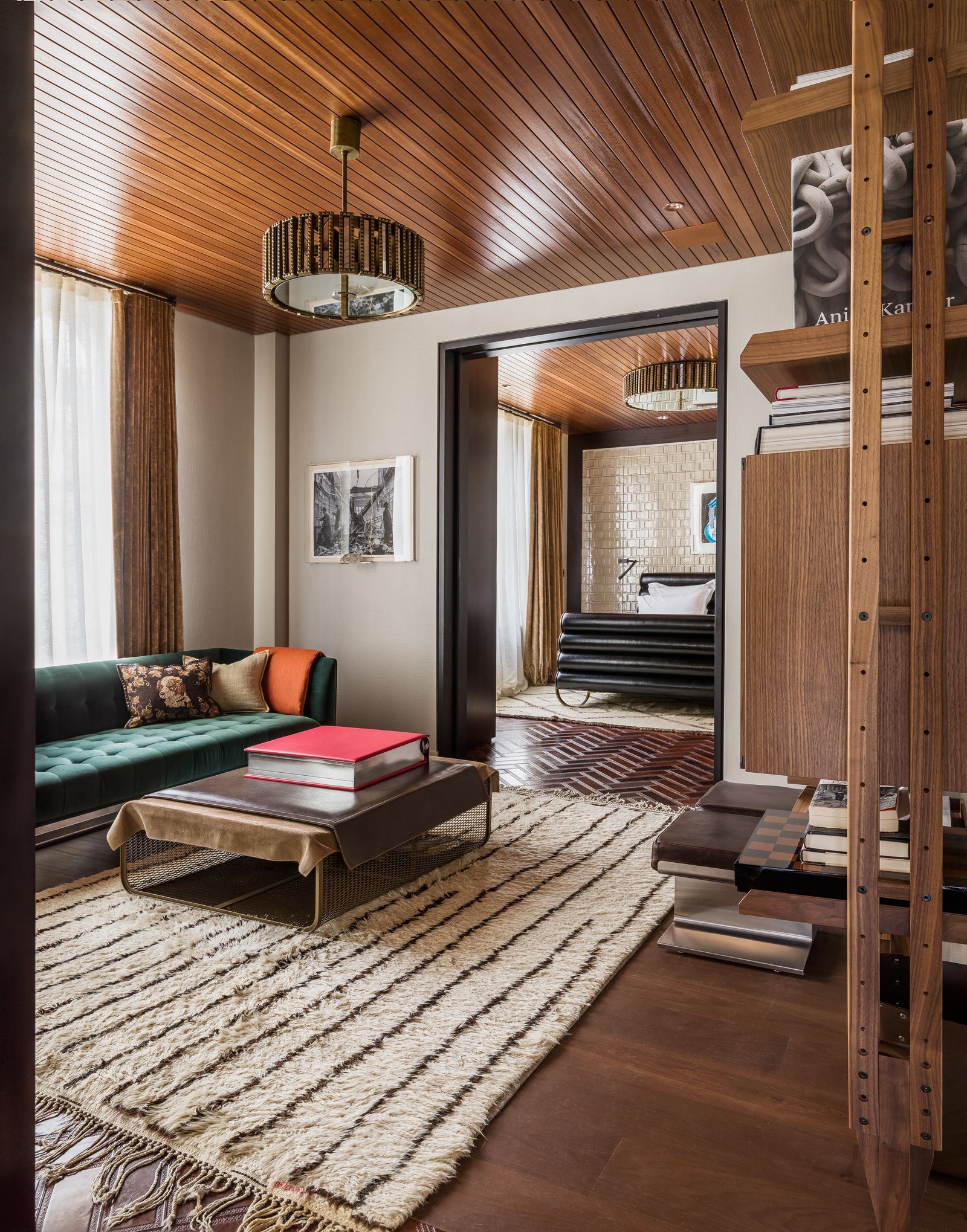 Image may contain Indoors Interior Design Home Decor Rug Wood Panels Lamp Couch and Furniture