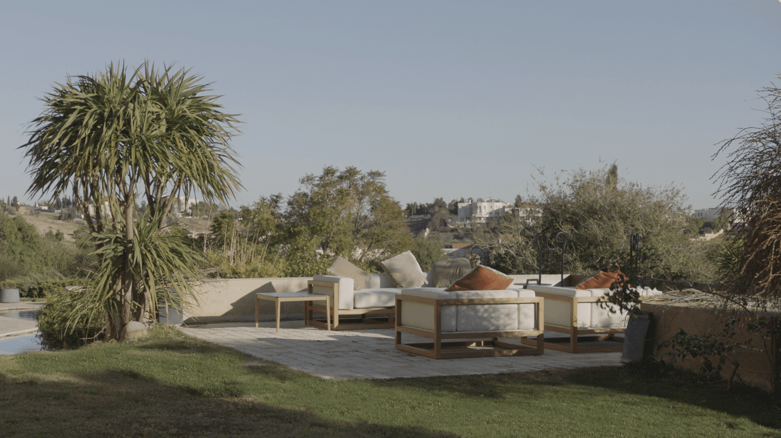 Image may contain Couch Furniture Architecture Building House Housing Patio Plywood Wood Home Decor and Grass